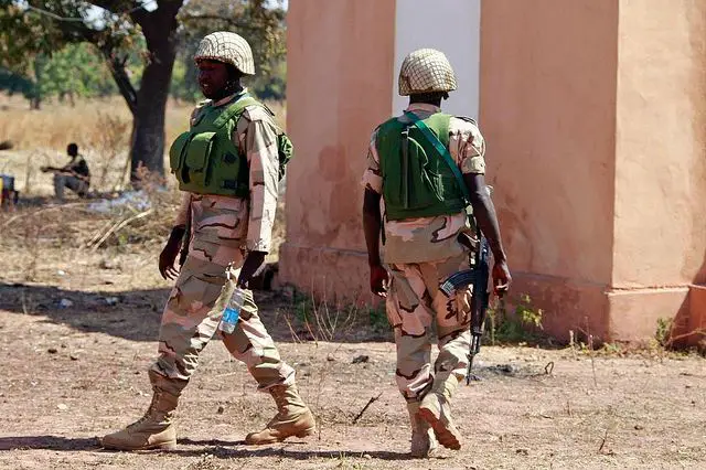 Nigerian soldiers walk at the Mali air force base near Bamako as troops await their deployment January 19, 2013. 