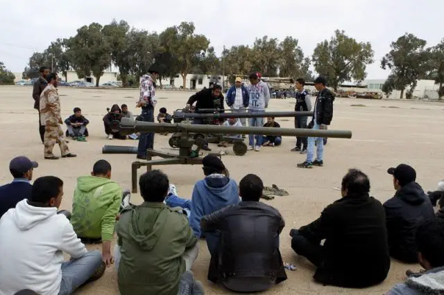 New volunteer Libyan rebel fighters receive training former servicemen of the old Gaddafi armed forces on how to use various weapons at a military camp in Benghazi. 