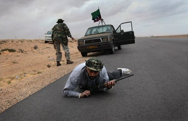 Libyan leader Moammar Gadhafi's forces appeared to be advancing Wednesday Match 09, 2011, on Ras Lanuf, using planes and heavy artillery in an effort to retake the eastern oil city.