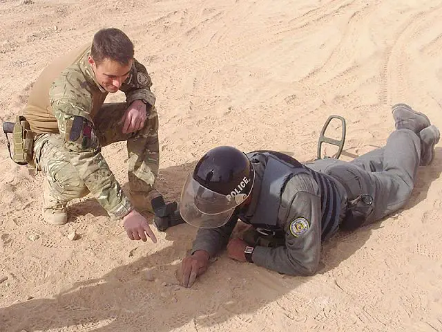 British Army mentor instructs an Afghan National Police recruit during a counter-improvised explosive device course in Helmand province