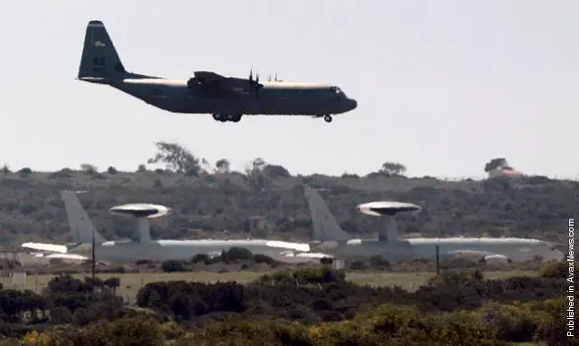 Warplanes and military transporters have begun arriving at Britain's Akrotiri airbase on Cyprus, less than 100 miles from the Syrian coast, in a sign of increasing preparations for a military strike against the Assad regime in Syria.