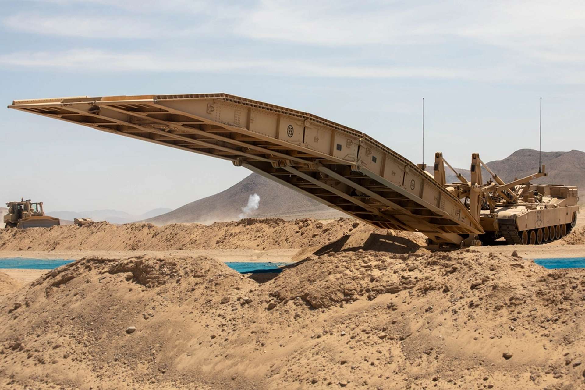 U.S. Army Joint Assault Bridge vehicles under a new $44.98 million DRS Sustainment Systems contract will expand protected gap-crossing capability, allowing Abrams-led armored formations to breach obstacles and maintain momentum in high-intensity combat (Picture source: U.S. DoW).