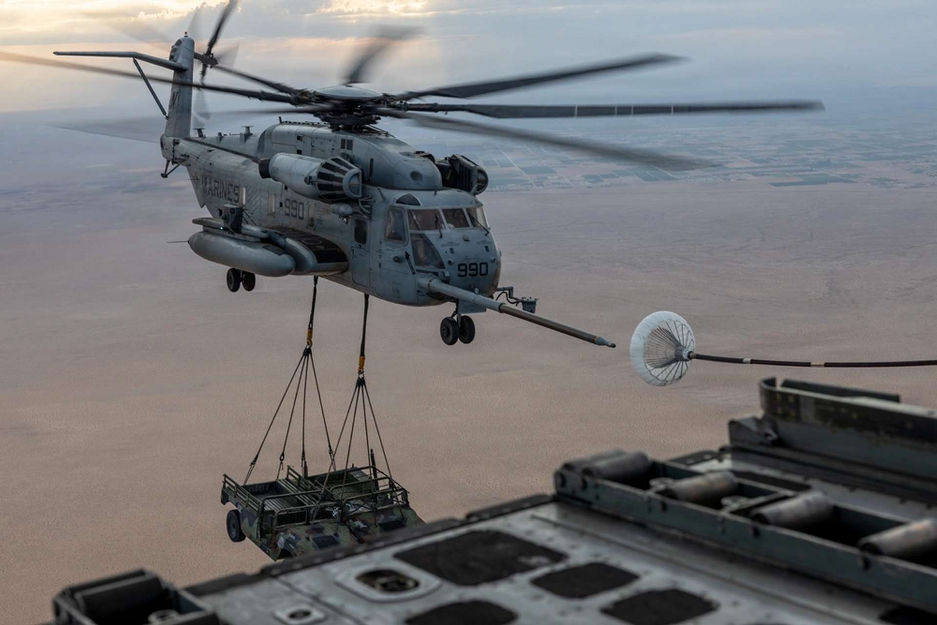 U.S. Marine Corps CH-53E Super Stallion helicopter conducts air-to-air refueling during WTI 2-26 near Yuma, Arizona, on March 31, 2026, while transporting two vehicles in a demanding heavy-lift mission that highlights the aircraft&rsquo;s long-range expeditionary logistics and battlefield sustainment role (Picture source: U.S. DoW).
