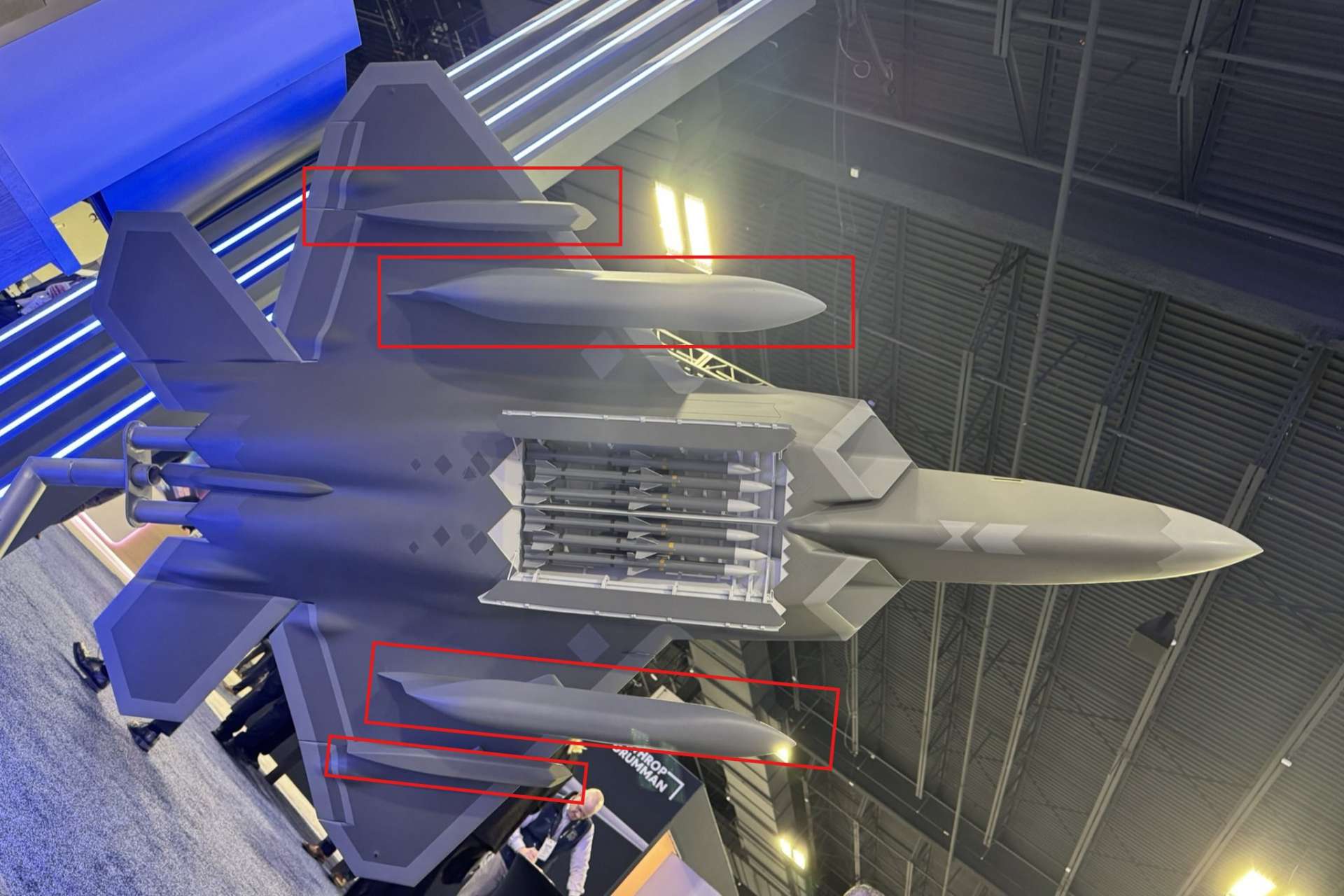 A scale model of the F-22 Raptor displayed at the Air & Space Forces Association Warfare Symposium 2026 revealed a previously unseen configuration featuring low observable external fuel tanks and underwing infrared search and track pods, signaling potential upgrades aimed at extending range and enhancing passive detection in contested airspace (Picture Source: X-account/@AlexHollings52)