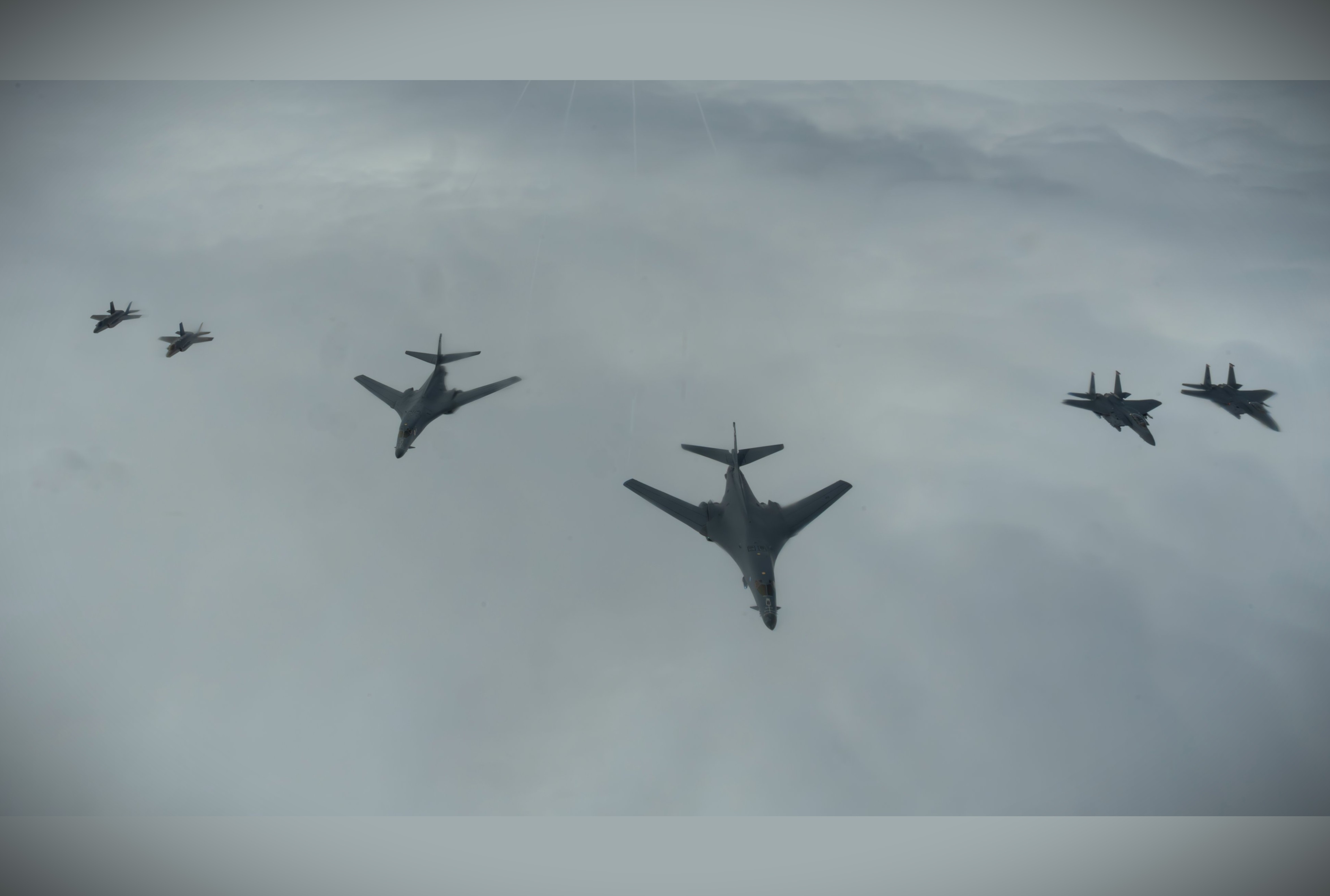 A U.S. Air Force formation of B-1B Lancer bombers, F-15E Strike Eagles, and F-35A Lightning II fighters over the North Sea during Astral Knight 26 showcased how bomber, fighter, tanker, and command-and-control assets are integrated into a single combat-ready airpower network for NATO defense operations (Picture Source: U.S. Air Force)