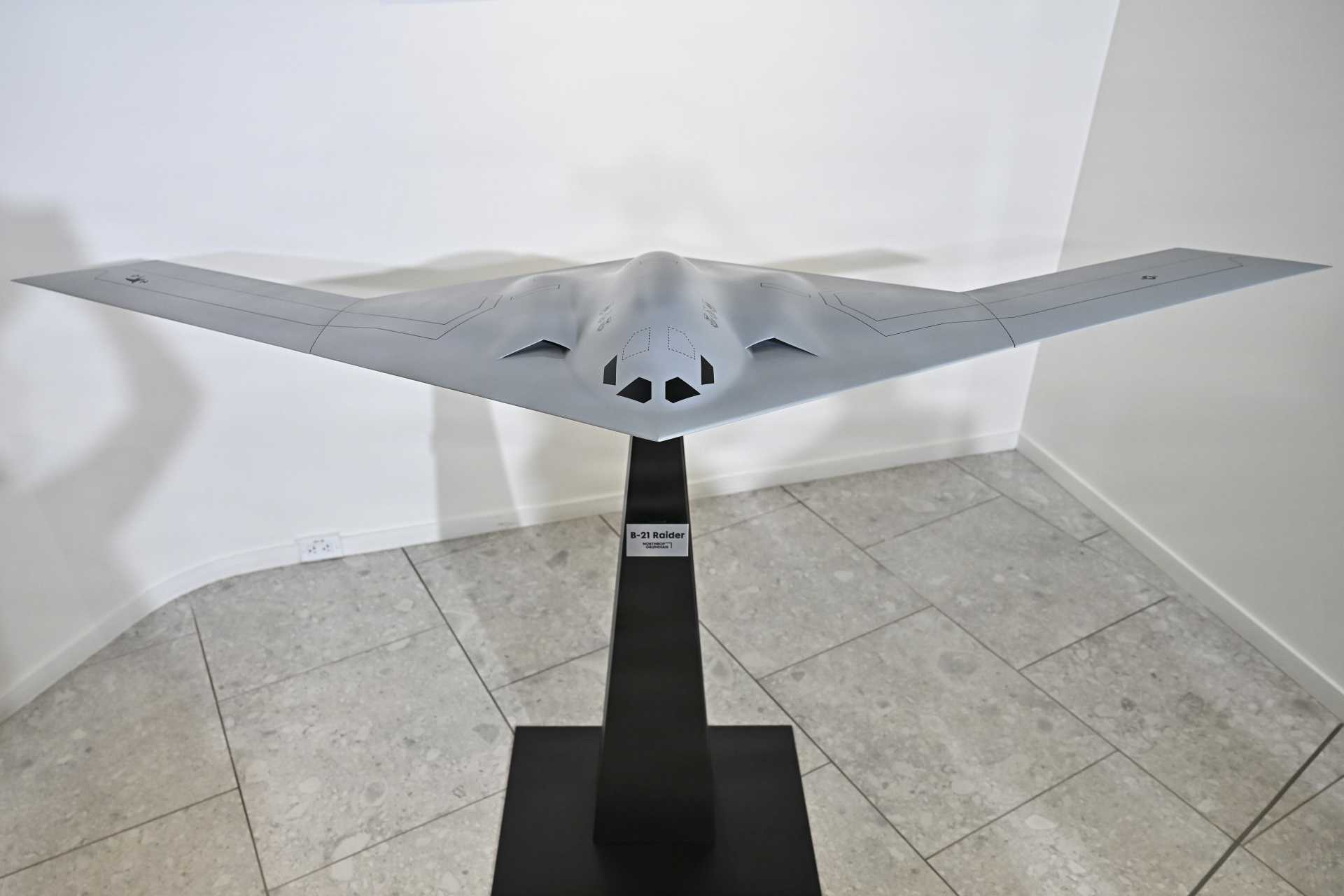 A scale model of the U.S. Air Force B-21 Raider strategic stealth bomber is presented during an official unveiling event at the Air and Space Forces Association headquarters in Arlington, Virginia, on April 17, 2026.