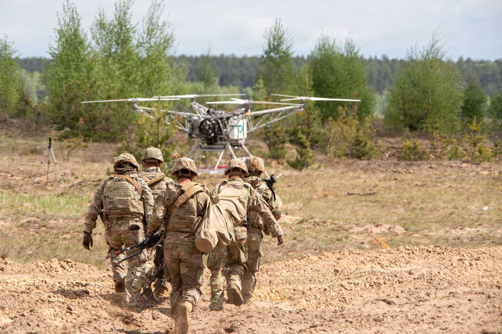 U.S. Army Soldiers prepare wounded casualty for autonomous evacuation aboard Flowcopter FC-100 drone during NATO exercise in Poland.