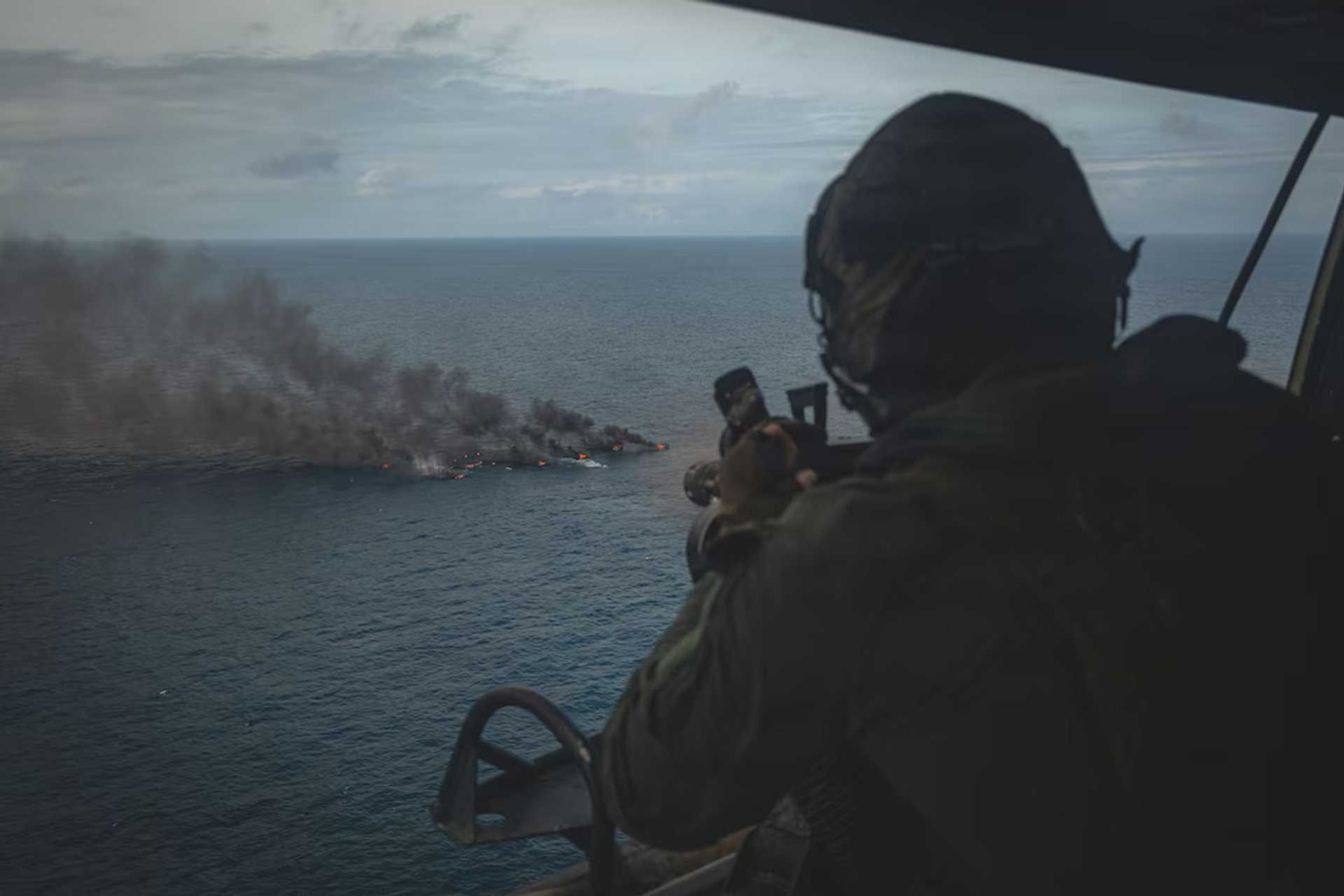 A U.S. Marine Corps UH-1Y Venom crew chief assigned to Marine Medium Tiltrotor Squadron (VMM) 365 (Reinforced), Littoral Combat Force-24, fires an M134 Minigun during a Maritime Interdiction Operation in the Pacific Ocean in September, 2026.