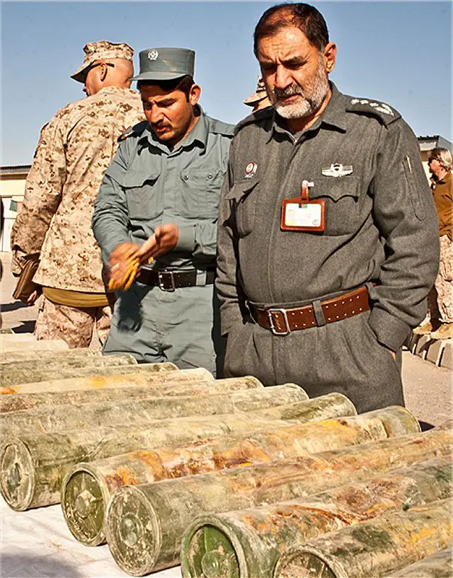 Helmand's Provincial Chief of Police, Colonel Ismail, inspects captured weaponry