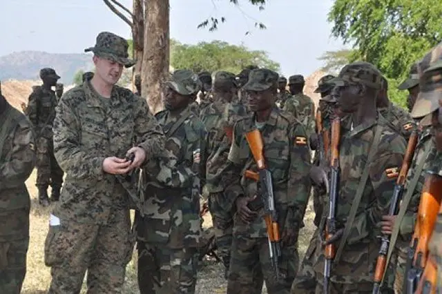 U.S. Marine Sergeant Steven Shettlesworth explains weapons handling tactics to a group of the Uganda People's Defence Force (UPDF) soldiers during ongoing counter-terrorism combat engineering training, March 2012.
