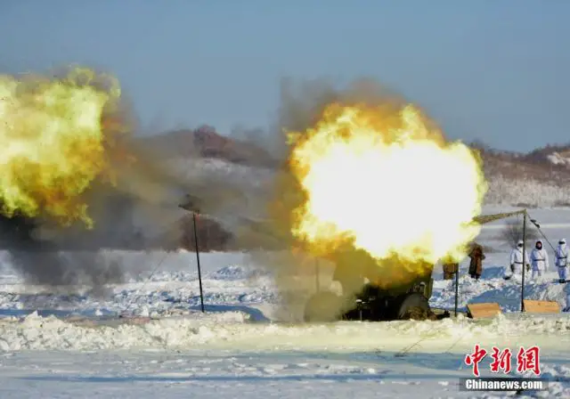 Chinese Army holds live fire military exercises in cold region of China with UAV (Unmanned Aerial Vehicle) and towed howitzer. Army of China use live fire exercises as an opportunity to use real ammunition in a realistically created combat situation.