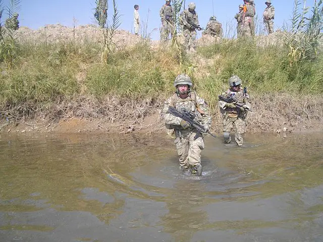 British army soldiers from C Company, 1st Battalion The Princess of Wales's Royal Regiment, wade into a river during Operation TORA GHAR