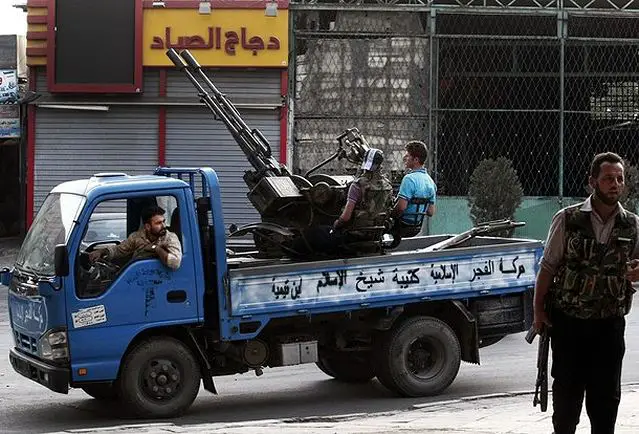 Free Syrian Army soldiers are seen at the border town of Azaz with ZU-23-2 anti-aircraft gun mounted on a light truck , some 20 miles (32 kilometers) north of Aleppo, Syria. 