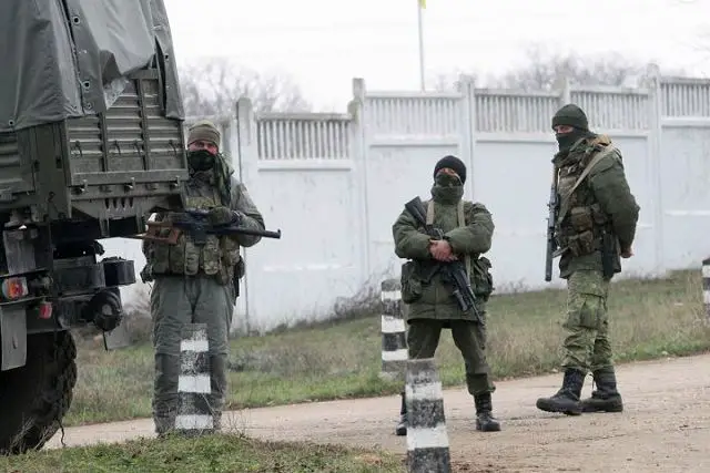 Armed men believed to be Russian seized a Ukrainian military base in Crimea Friday, March 7, 2014. Witnesses say Russian troops broke through the gate of a missile defense base with a military vehicle, trying to break into a command post, but no shots were fired, Interfax Ukraine reported.