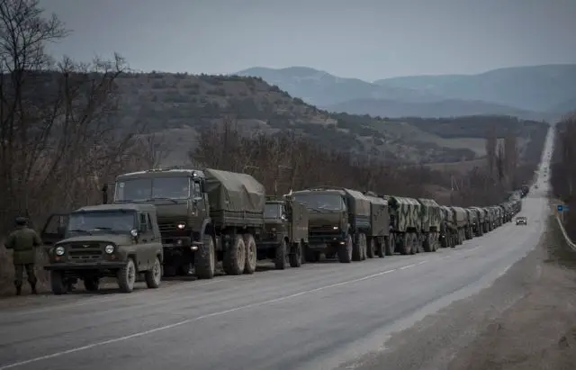 According to Reuters, dozens of military trucks transporting heavily armed soldiers rumbled over Crimea's rutted roads Saturday, March 8, 2014, as Russia reinforced its armed presence on the disputed peninsula in the Black Sea. The convoy was accompanied by eight armoured vehicles, two ambulances, military kitchen truck, petrol tankers and other hardware. 