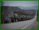 According to Reuters, dozens of military trucks transporting heavily armed soldiers rumbled over Crimea's rutted roads Saturday, March 8, 2014, as Russia reinforced its armed presence on the disputed peninsula in the Black Sea. The convoy was accompanied by eight armoured vehicles, two ambulances, military kitchen truck, petrol tankers and other hardware. 