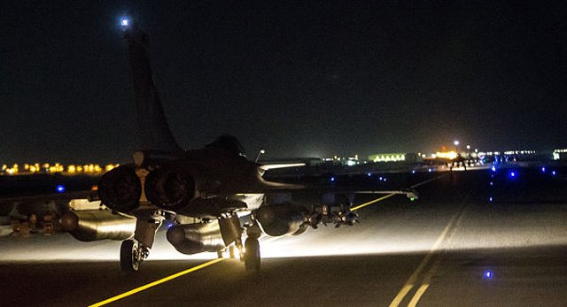 France has launched “massive” air strikes on the Islamic State group’s de-facto capital in Syria, destroying a jihadi training camp and a munitions dump in the city of Raqqa, where Iraqi intelligence officials say the attacks on Paris were planned.