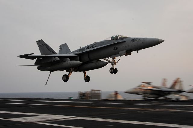 An U.S. F/A-18C Hornet lands on the flight deck of the aircraft carrier USS Theodore Roosevelt deployed in the U.S. 5th Fleet area of operations supporting Operation Inherent Resolve, strike operations in Iraq and Syria. (Photo US Navy)