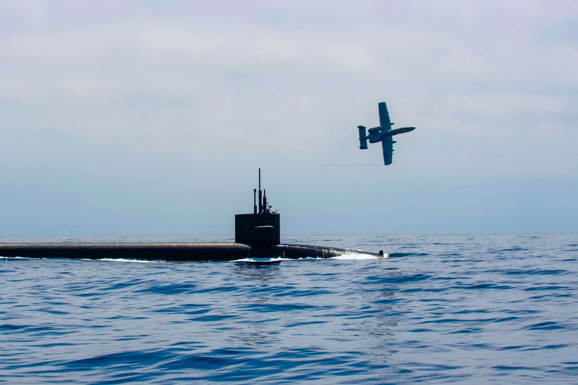 An A-10 Thunderbolt II provided armed overwatch for the Ohio-class ballistic missile submarine USS Nebraska during surfaced operations in the Pacific Ocean (Picture Source: U.S. Navy)