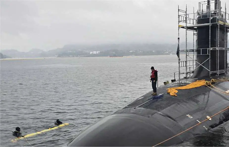 U.S. Navy divers operate a Yellow Moray REMUS 600 unmanned underwater vehicle alongside Virginia-class fast-attack submarine USS Delaware (SSN 791) during testing in Norway in 2025. The exercise demonstrated torpedo-tube launch and recovery of an unmanned underwater vehicle, providing a technological foundation for future submerged logistics missions.