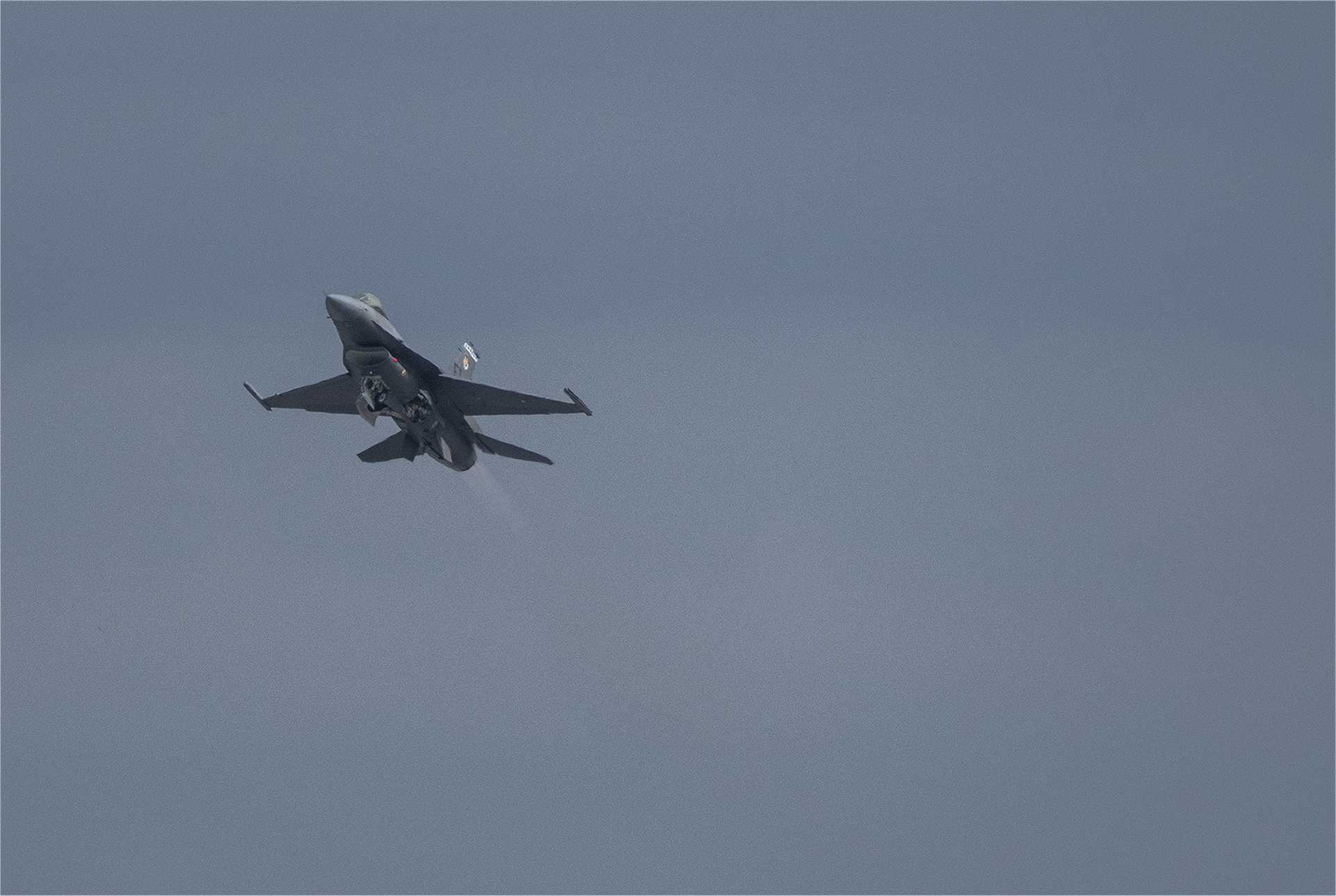 A U.S. Air Force F-16 Fighting Falcon fighter jet modified for the Viper Experimentation and Next-generation Operations Model–Autonomy Flying Testbed (VENOM) program conducts autonomous systems flight testing at Eglin Air Force Base, Florida, in June 2026.