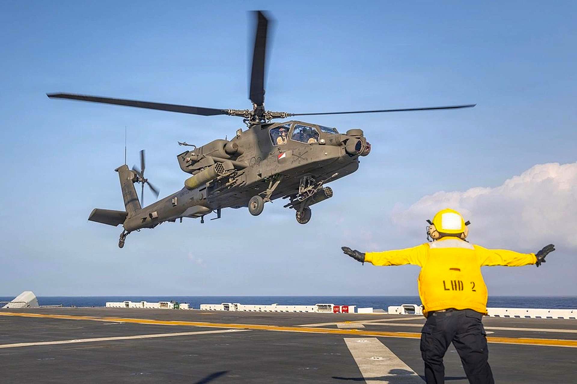 A U.S. Army AH-64 Apache launched from USS Essex during RIMPAC 2026, demonstrating how amphibious ships could serve as mobile strike and sustainment nodes for distributed Pacific operations (Picture Source: U.S. Army)
