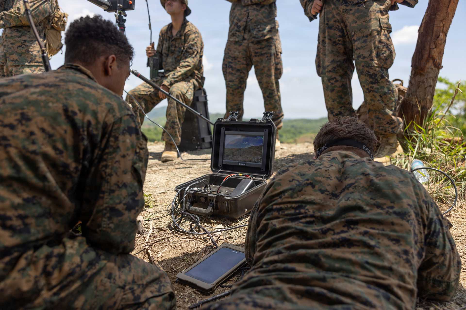 U.S. Marines assigned to the 3rd Littoral Combat Team, 3rd Marine Littoral Regiment, 3rd Marine Division, monitor the live video feed from an unmanned aerial system during dry-fire training at Fort Magsaysay, Nueva Ecija, Philippines, on June 14, 2026, as they prepare for KAMANDAG 10.