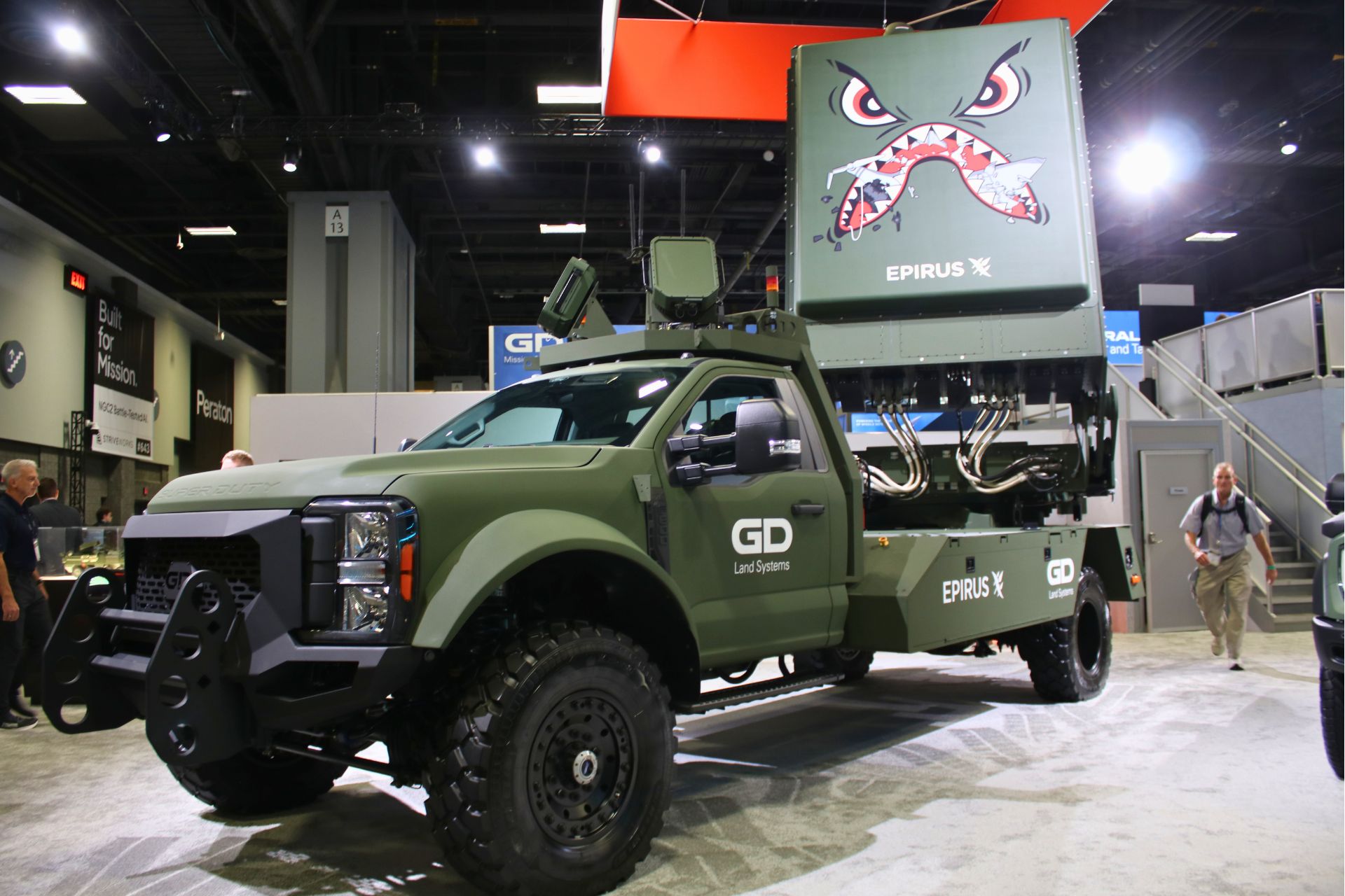 General Dynamics Land Systems unveiled the Leonidas GV, a mobile high-power microwave counter-drone vehicle designed to defeat coordinated drone swarms while preserving costly kinetic interceptors (Picture Source: Army Recognition Group)