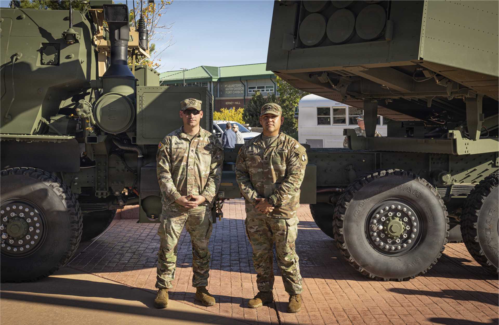 U.S. Army Sgt. 1st Class Matthew Nethers (left) and Sgt. 1st Class Nicolas Adame, assigned to Bravo Company, 1st Battalion, 10th Field Artillery Regiment, 4th Multi-Domain Task Force, stand in front of an M142 HIMARS rocket artillery system during the unit's activation ceremony at Fort Carson, Colorado, on October 8, 2026. (Picture source: U.S. Army)
