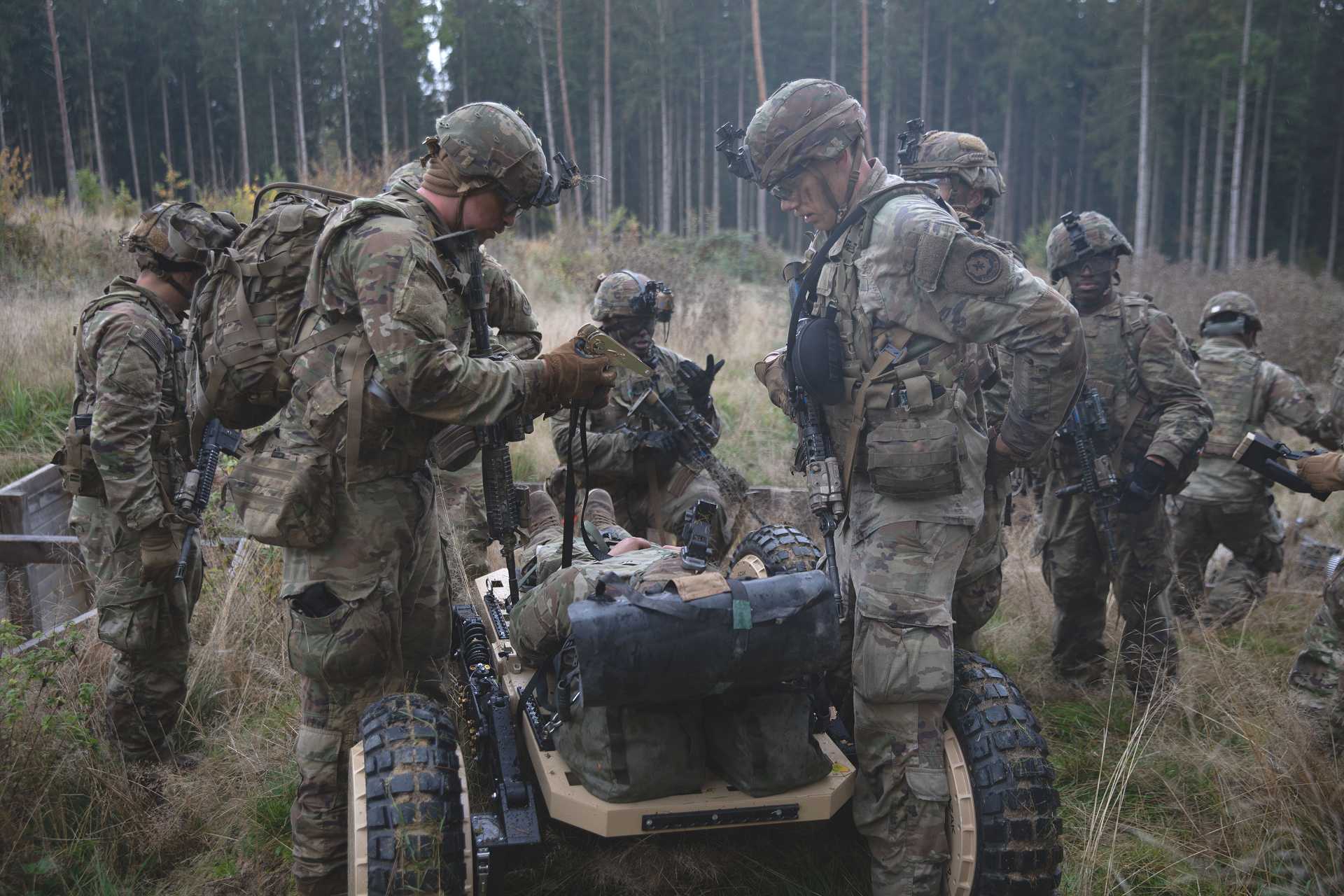 U.S. Army soldiers from 2nd Squadron, 2nd Cavalry Regiment, use an AZAK S26 unmanned ground vehicle to evacuate a simulated casualty during a platoon training exercise at Grafenwoehr Training Area, Germany, on October 21, 2026. (Picture source: U.S. Department of War/Defense)
