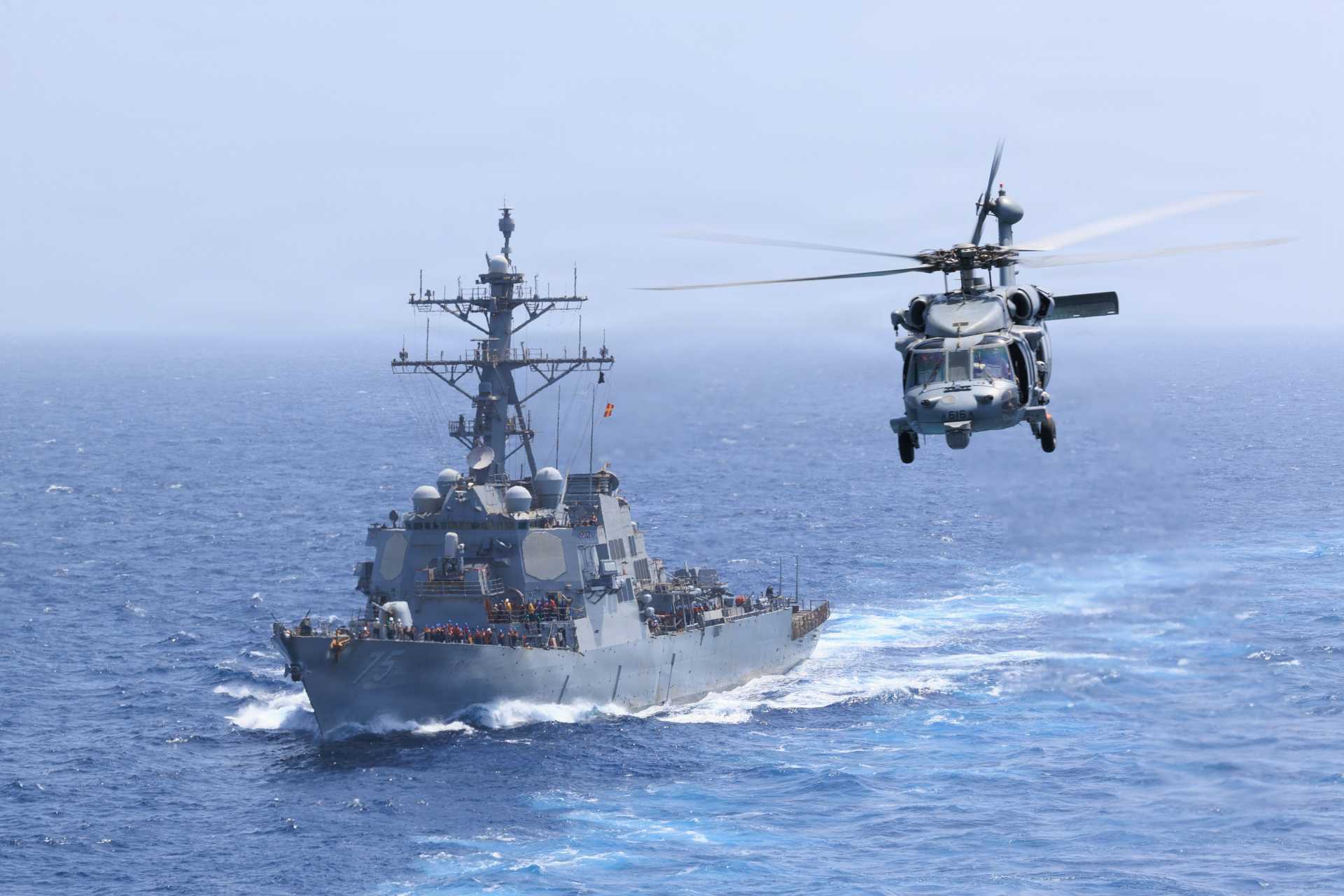 The U.S. Navy USS Donald Cook (DDG-75) sails alongside USS George H.W. Bush (CVN-77) on June 18, 2026. Although the destroyer appears fully operational externally, the U.S. Navy later disclosed that its Mk 45 5-inch gun had been affected by a two-year internal fire-control casualty before being restored to service.
