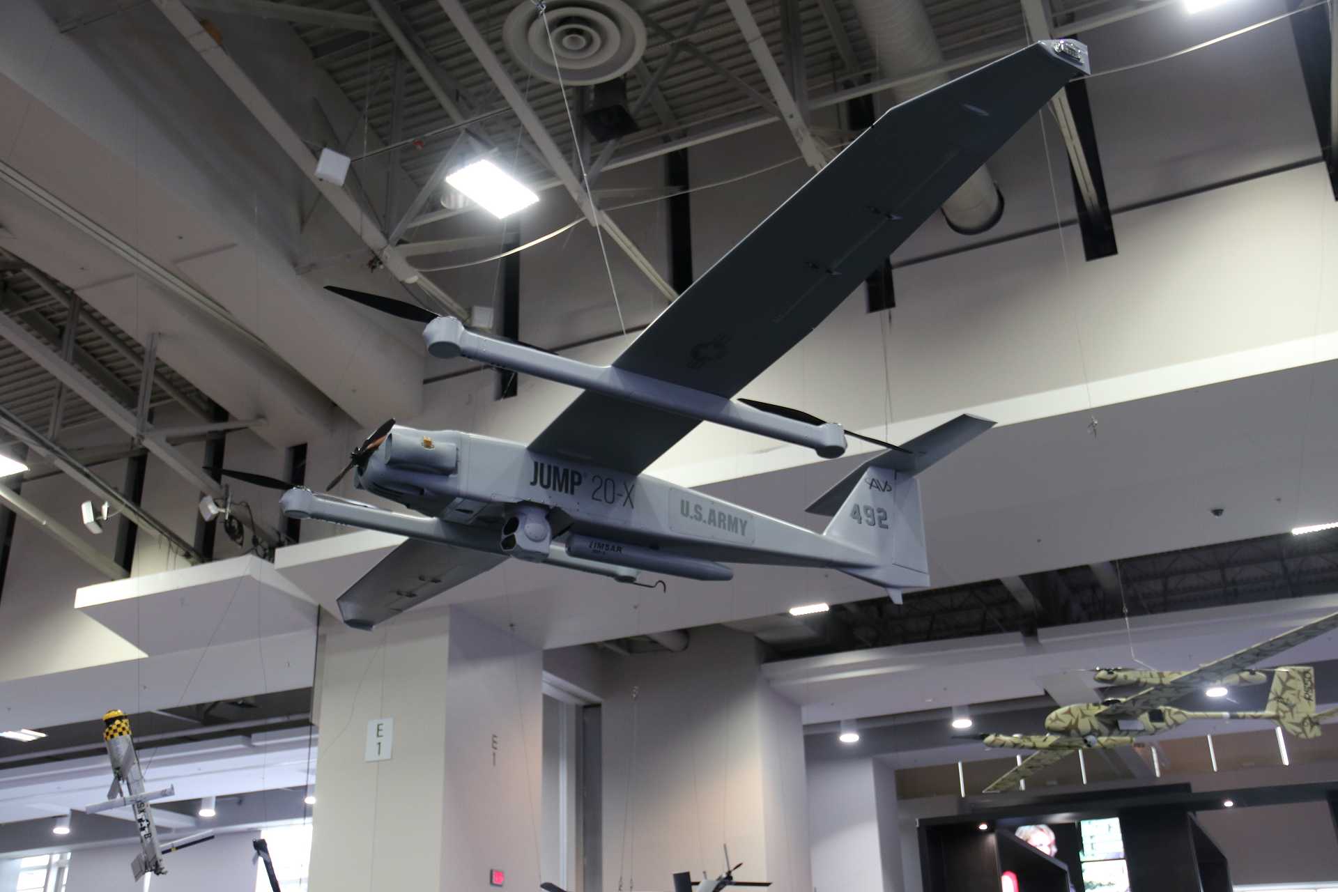 AeroVironment drones displayed at the company's booth during AUSA 2026 in Washington, D.C., highlighting the Pentagon's ambition to invest approximately $50 billion in scaling autonomous weapons production from thousands to potentially millions of systems.