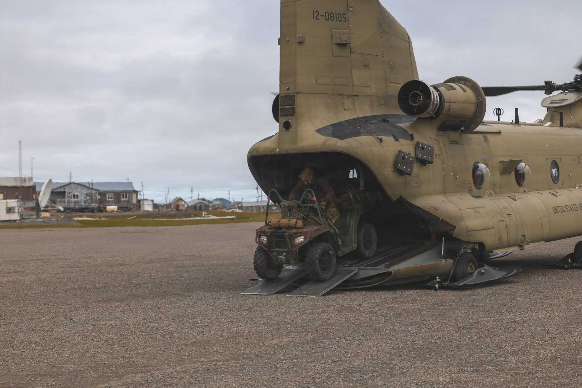 U.S. Army Green Berets from the 10th Special Forces Group (Airborne) unload an all-terrain vehicle from a CH-47 Chinook after landing at Savoonga on St. Lawrence Island, Alaska, during Operation Polar Dagger 2026. The insertion demonstrated the ability to rapidly deploy Special Operations Forces with ground mobility assets into remote Arctic terrain in support of U.S. homeland defense.