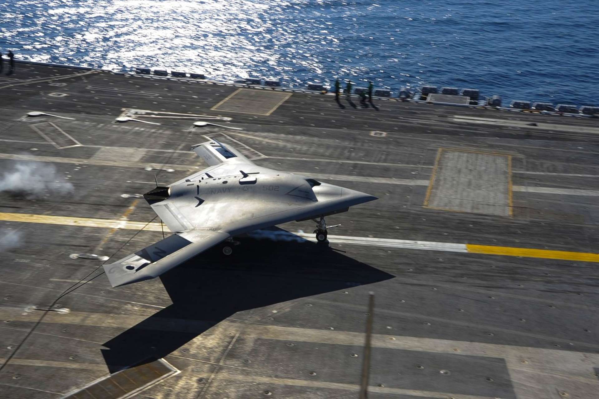 The X-47B Unmanned Combat Air System demonstrator taxis aboard USS Harry S. Truman (CVN 75), whose pioneering unmanned aircraft trials helped establish experience relevant to the U.S. Navy’s current push for carrier-capable Collaborative Combat Aircraft operating from Ford and Nimitz-class carriers (Picture Source: U.S. Navy)
