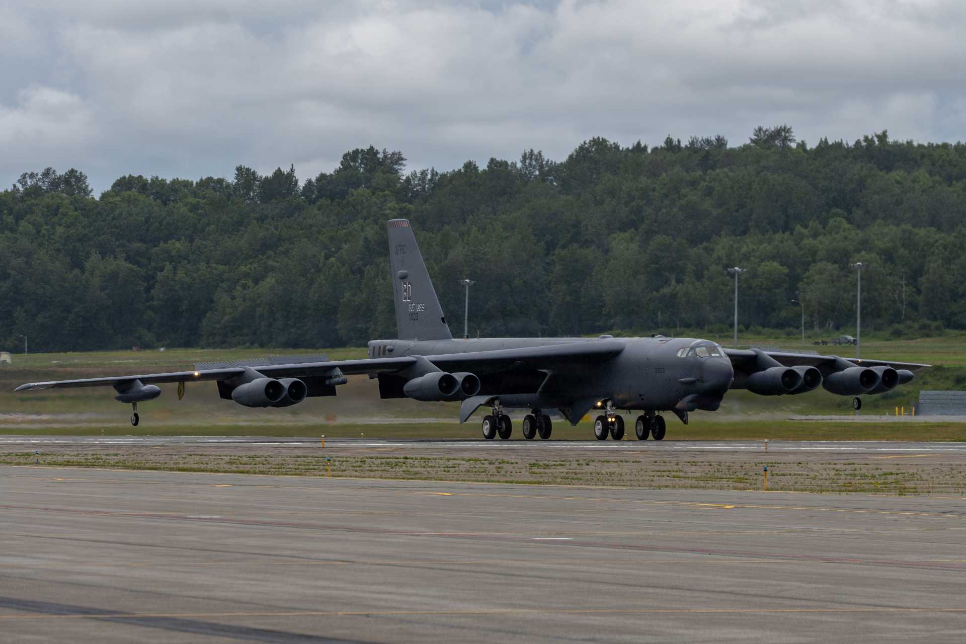 A U.S. Air Force B-52H Stratofortress lands at Joint Base Elmendorf-Richardson, Alaska, on August 5, 2026, ahead of the Arctic Thunder Open House. The long-range strategic bomber is undergoing major modernization toward the future B-52J configuration, including Rolls-Royce F130 engines and a new AESA radar intended to keep the aircraft operational into the 2050s and beyond.