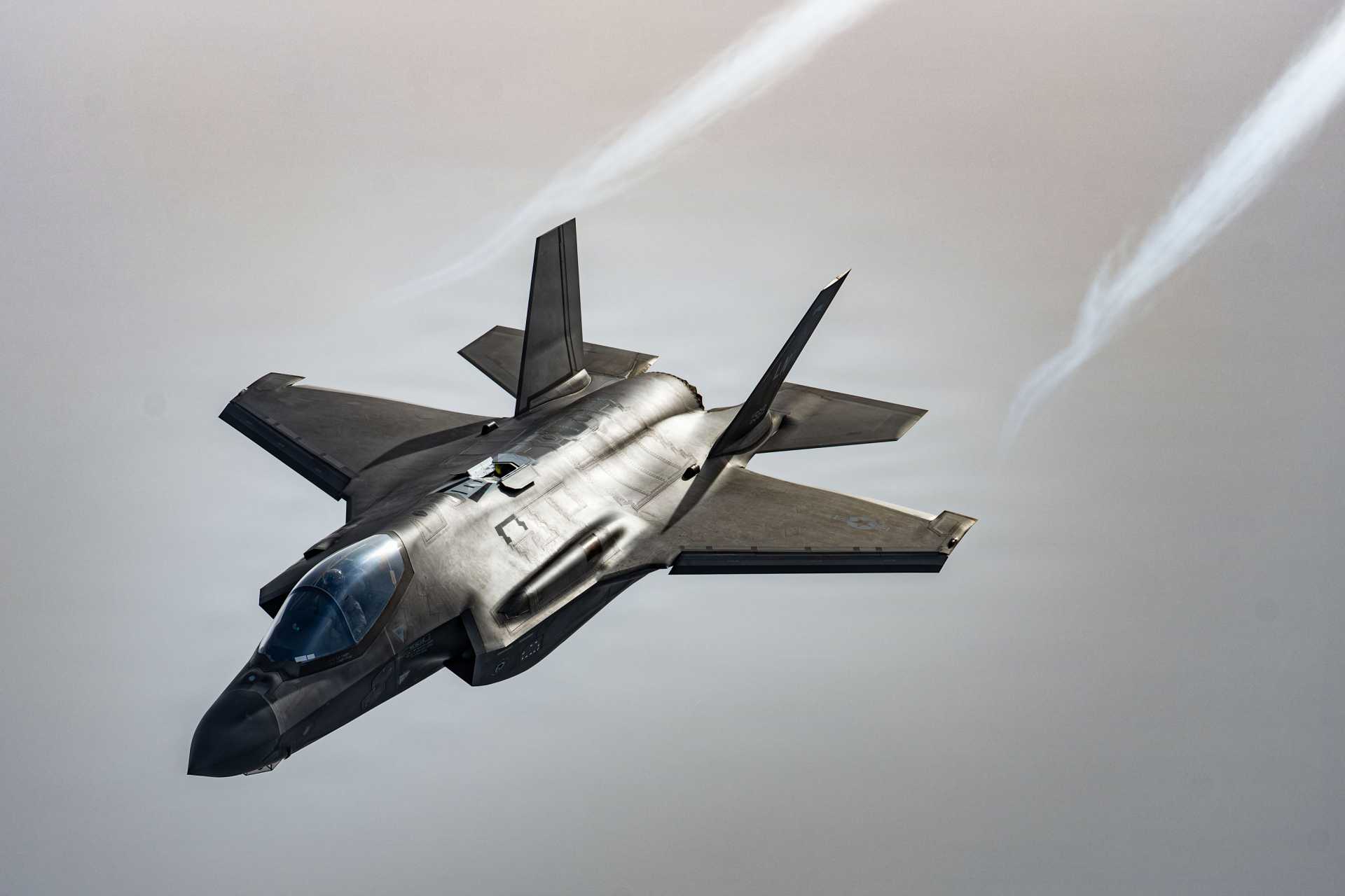 A U.S. Air Force F-35 Lightning II assigned to the 48th Fighter Wing flies over the North Sea during Exercise Point Blank on January 29, 2026. The Pentagon plans to add a Starshield-enabled Beyond Line of Sight satellite communications capability to the F-35 by 2031, allowing the fighter to exchange track data across extended distances for long-range kill-chain management.