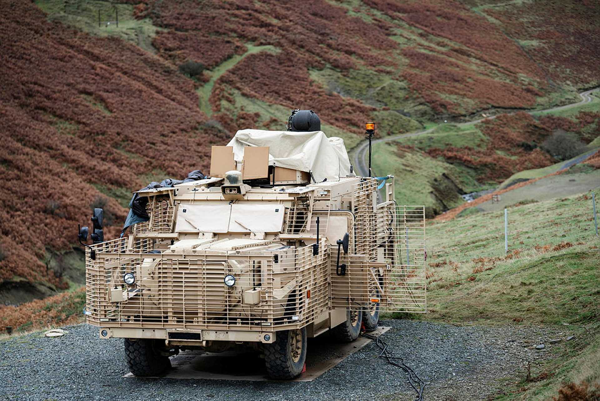 British Army Wolfhound protected mobility vehicle equipped with the high-energy Laser Directed Energy Weapon demonstrator during earlier UK trials. The technology provides a direct precursor to Project PANOPTES, which seeks an autonomous vehicle-mounted counter-UAS capability able to defeat mass drone attacks while preserving conventional missile stocks.