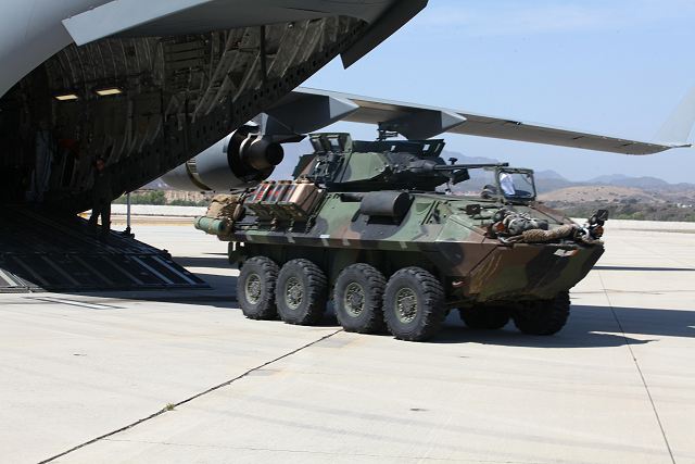 As Marines climb aboard their light armored vehicles, the deafening noise of the C-17 Globemaster and its four large turbofan engines echoes across the airfield during a strategic mobility exercise here, April 24, where land vehicles joined forces with aircraft.