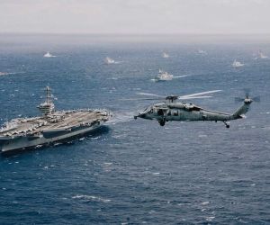 U.S. Navy Nimitz-class aircraft carrier USS Theodore Roosevelt (CVN 71) leads a multinational formation during RIMPAC 2026 in the Pacific. U.S. Navy commanders are examining how unmanned underwater vehicles could eventually transfer critical components between aircraft carriers and submerged submarines.