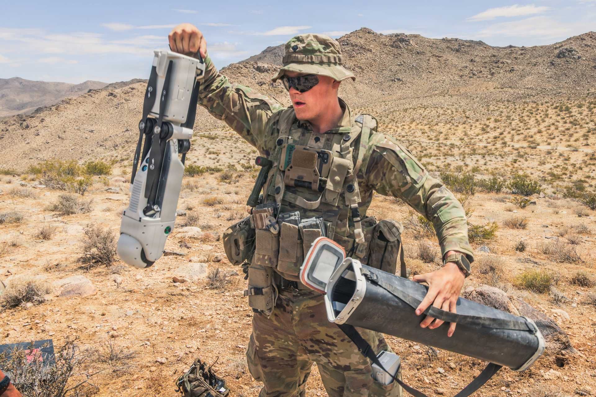 U.S. Army Spc. Tanner Shanklin, assigned to the 4th Infantry Division, prepares a Rogue 1 unmanned aerial system for employment during Project Convergence Capstone 6 at Fort Irwin, California, on July 20, 2026. The man-portable VTOL loitering munition is being evaluated for reconnaissance and precision-strike missions against targets beyond direct line of sight.