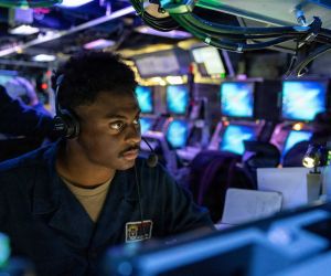 A U.S. Navy Fire Controlman monitors the Aegis Weapon System aboard the Arleigh Burke-class guided-missile destroyer USS Mustin (DDG 89) during a combat systems training drill in the Indian Ocean on June 25, 2026.