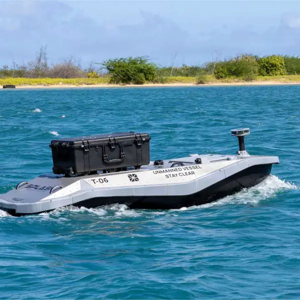 A digitally crewed uncrewed surface vessel departs Sand Island near Honolulu, Hawaii, carrying components for an embarked additive manufacturing system aboard the Wasp-class amphibious assault ship USS Essex (LHD 2) during Exercise Rim of the Pacific (RIMPAC) 2026 on July 7, 2026.