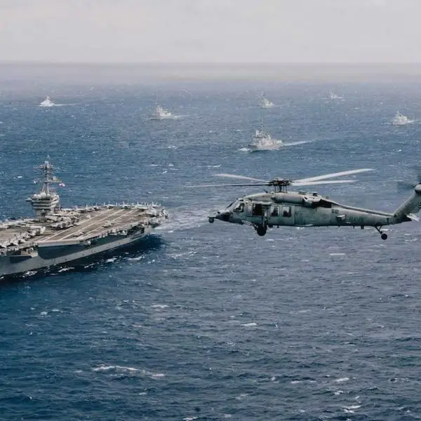 U.S. Navy Nimitz-class aircraft carrier USS Theodore Roosevelt (CVN 71) leads a multinational formation during RIMPAC 2026 in the Pacific. U.S. Navy commanders are examining how unmanned underwater vehicles could eventually transfer critical components between aircraft carriers and submerged submarines.