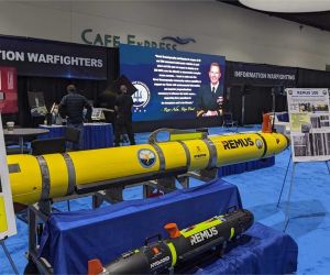 The U.S. Naval Oceanography booth displays Remote Environmental Measuring Units (REMUS) unmanned underwater vehicles (UUVs), designed to support autonomous undersea missions including oceanographic survey, environmental data collection, reconnaissance, and mine countermeasures.