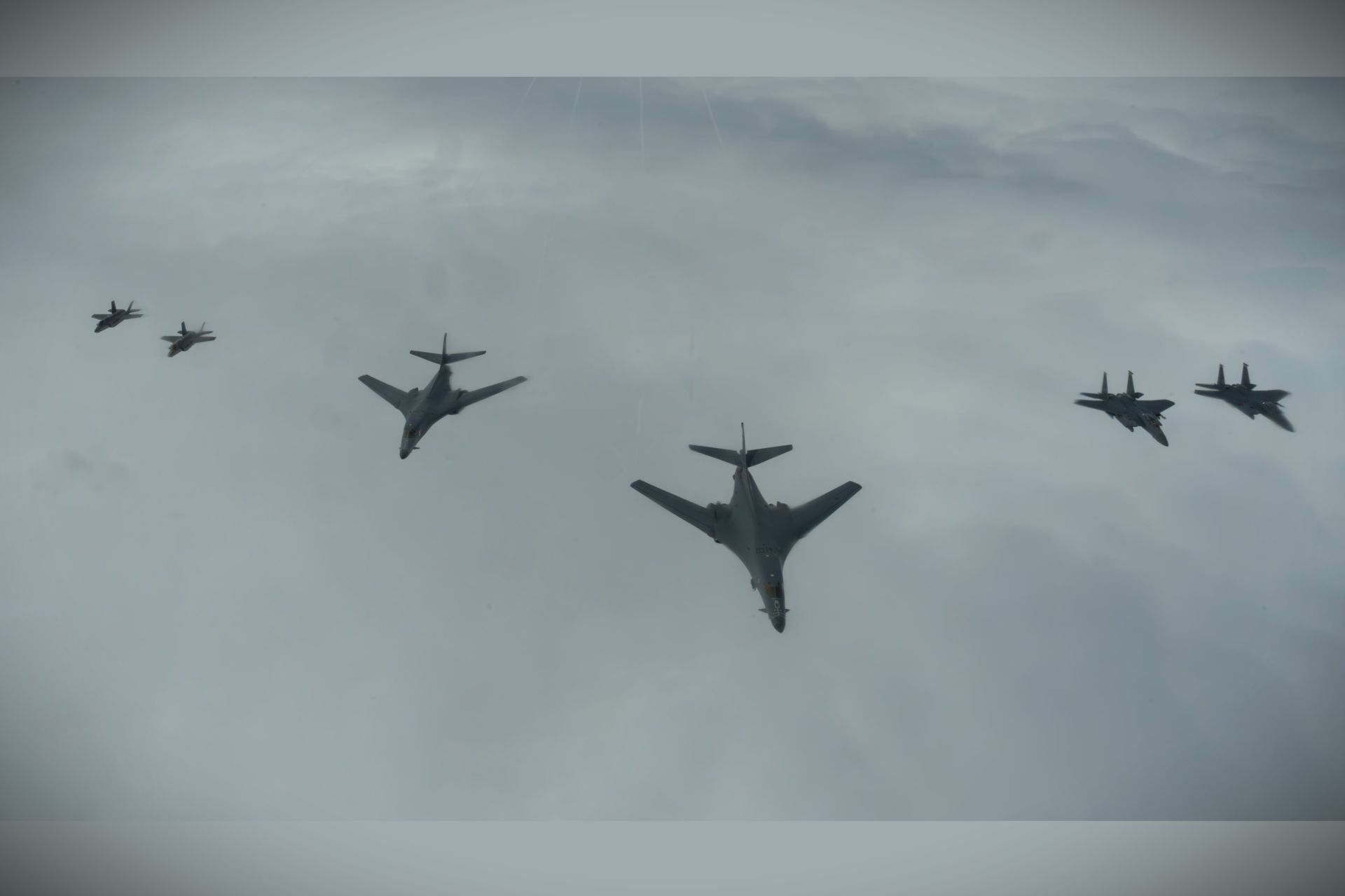 A U.S. Air Force formation of B-1B Lancer bombers, F-15E Strike Eagles, and F-35A Lightning II fighters over the North Sea during Astral Knight 26 showcased how bomber, fighter, tanker, and command-and-control assets are integrated into a single combat-ready airpower network for NATO defense operations (Picture Source: U.S. Air Force)