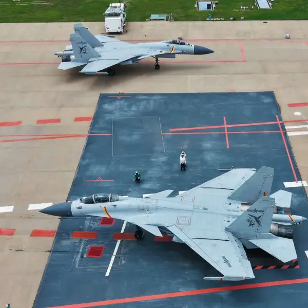 Chinese J-15 carrier-based fighters conduct land-based takeoff and landing drills designed to expand pilot qualification, deck-handling proficiency, and sortie-generation capacity for the Liaoning, Shandong, and Fujian aircraft carriers (Picture source: Chinese MoD).