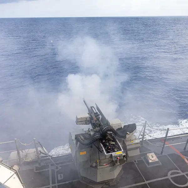 A Mk 38 Mod 4 30mm gun fires during a live-fire exercise aboard the Arleigh Burke-class guided-missile destroyer USS Mustin (DDG 89) in the South China Sea on April 17, 2026.