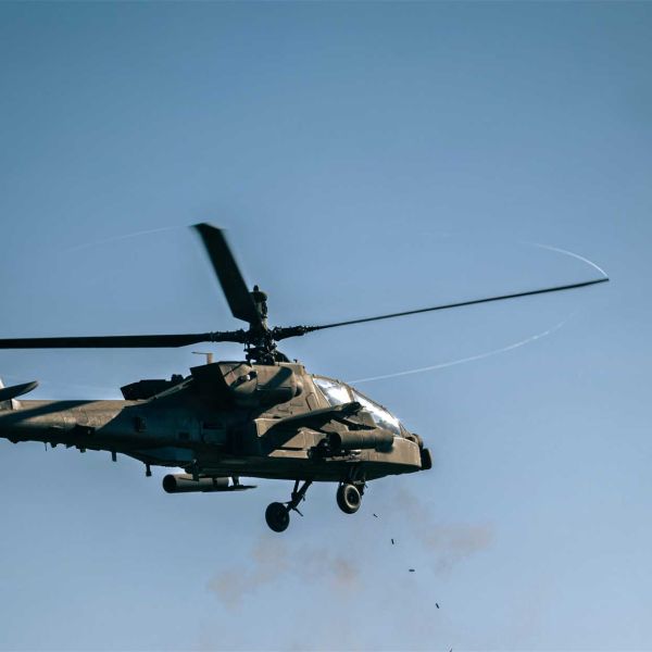 A U.S. Army AH-64 Apache from the 12th Combat Aviation Brigade fires its 30 mm chain gun during Operation Skyfall II at Grafenwoehr Training Area, Germany, on October 6, 2026. In the foreground, an AN/MPQ-64 Sentinel radar assigned to the 52nd Air Defense Artillery Brigade tracks the aerial target, supporting the helicopter’s counter-drone engagement. (Picture source: U.S. Department of War/Defense)