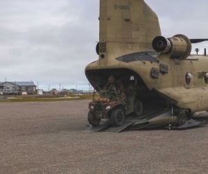 U.S. Army Green Berets from the 10th Special Forces Group (Airborne) unload an all-terrain vehicle from a CH-47 Chinook after landing at Savoonga on St. Lawrence Island, Alaska, during Operation Polar Dagger 2026. The insertion demonstrated the ability to rapidly deploy Special Operations Forces with ground mobility assets into remote Arctic terrain in support of U.S. homeland defense.