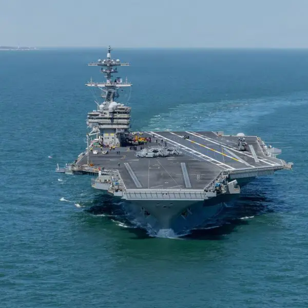 The U.S. Navy's nuclear-powered aircraft carrier USS George H.W. Bush (CVN-77), pictured departing Norfolk in March 2026, has reportedly returned to the Arabian Sea, joining USS George Washington to expand American carrier-based air operations near Iran. (Picture source: U.S. Navy)
